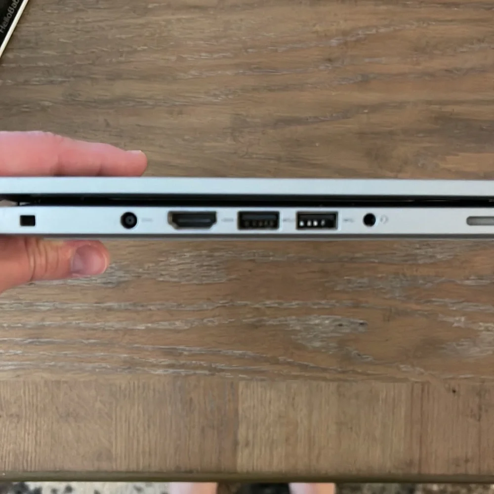 Silver Dell laptop that folds over to a tablet
